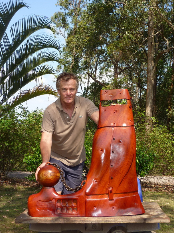 Jack Wilms with a carved red cedar artwork at Obi Valley Woodworks